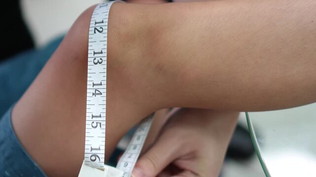 Side View of Measuring Knee Circumference with Measuring Tape Real Footage