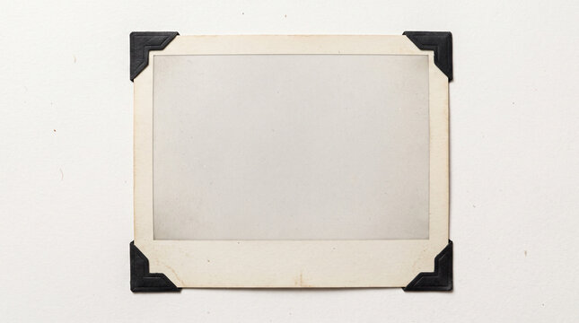 Vintage empty photo frame mockup with black corner tabs isolated on white background paper texture