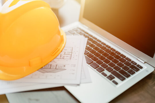 Construction Engineer Safety Helmets on Laptop Computer Architect, Home Construction Engineering.