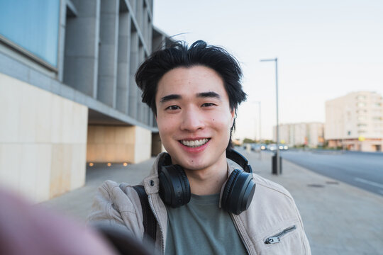 Young asian man smiling taking selfie lifestyle
