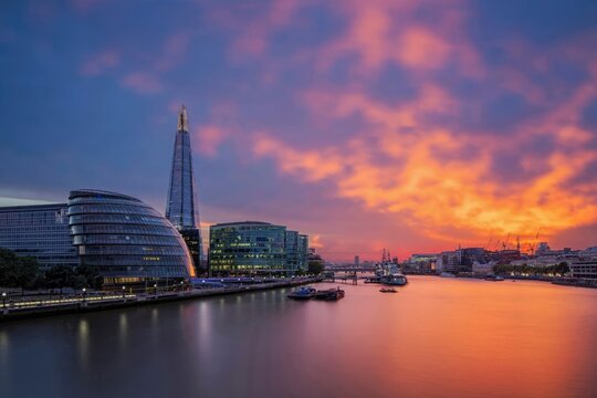 City skyline with river at sunset and colorful sky