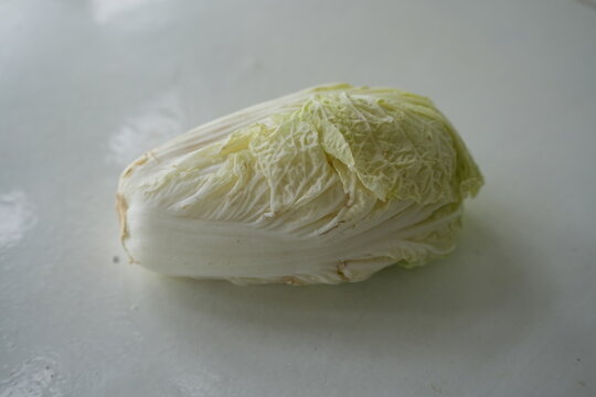 Fresh napa cabbage leaves arranged on a clean white surface, highlighting crisp texture and healthy vegetable ingredients for salads, soups, stir-fries, and meal preparation. Ideal for nutrition 