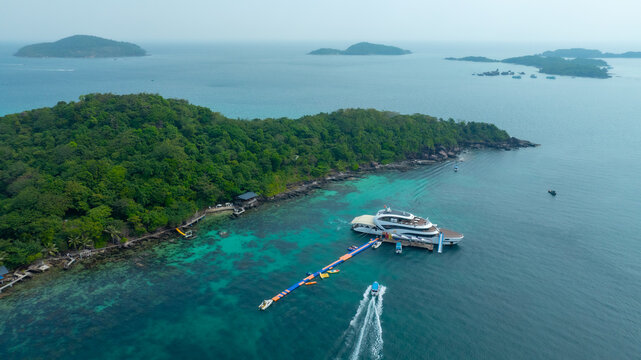Aerial view of beautiful landscape, tourism boats, and people swimming on the sea and beach on May Rut and Mong Tay island in Phu Quoc, Kien Giang province, Vietnam