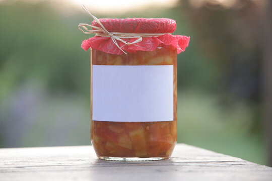 Homemade vegetable stew in glass jar with blank label, preserved for winter storage