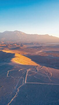 Aerial desert valley with winding geoglyph paths