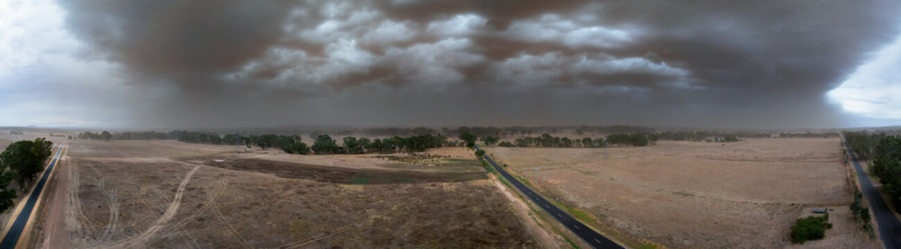 Aerial panorama view of a summer dust storm approaching over dry farmland