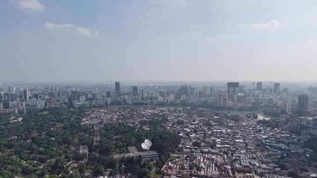 Drone view of Karail slum greenery forest and modern Gulshan skyline