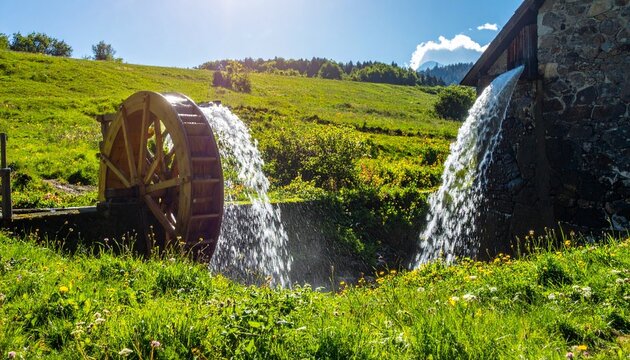 Majestic waterfall cascading through lush green valley with rocky cliffs.