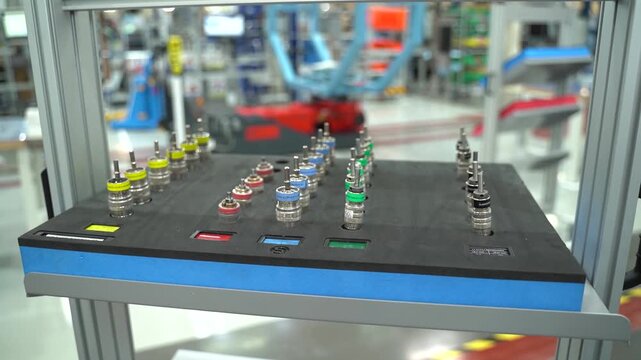 Wide view of color coded precision tooling inserts on a foam board