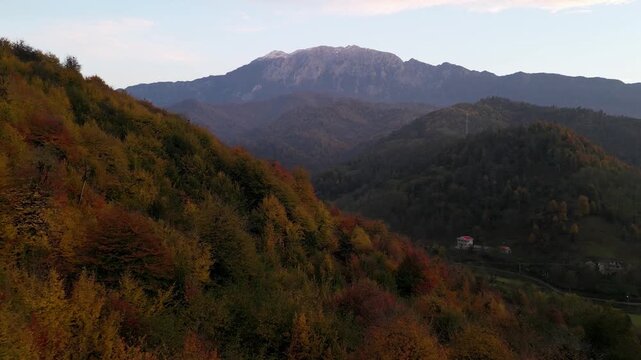 Aerial landscape of mountain highland hills Hyrcanian forest Iran autumn foliage ironwood tree beech forest colorful leaves drone ecotourism conservation ecology natural reserve rural scenery hiking