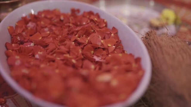 White bowl filled with soft pink rose petals for natural floral decoration for wedding rituals