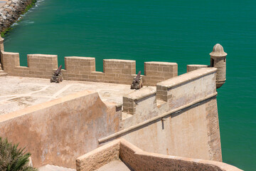 The historic cannons of the Sqala watch over the turquoise waters from the Kasbah of the Udayas in Rabat, Morocco © Uvamenfoto