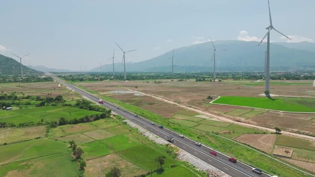 Aerial Drone View of Vinh Hao Expressway Passing Wind Turbines and Rural Landscape in Vietnam