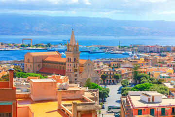 Obraz premium Messina Italy showcases iconic cathedral and astronomical clock tower overlooking harbor. Sunshine illuminates the coastal cityscape as ships traverse scenic blue waters of the strait