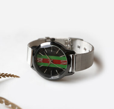 Elegant Black Round Wristwatch with Silver Mesh Strap and Striped Dial on White Background