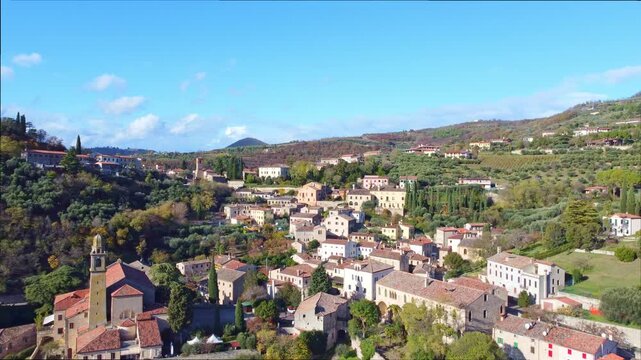 The clip presents a smooth aerial flyover of Arqu&agrave; Petrarca and the Euganean Hills, showcasing rolling green landscapes, historic rural architecture and natural terrain shaped by ancient volcanic orig