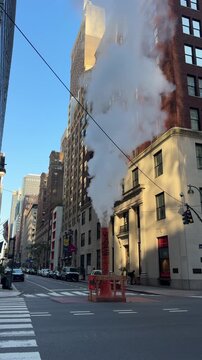 City street corner with thick white steam rising from the road.