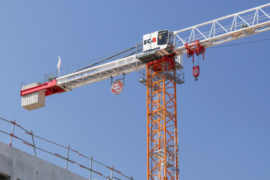 Nancy, France - June 20th 2026 : View on a flat-top tower crane Liebherr 250 EC-B 12 Litronic on a construction site for the construction of a building with the blue sky.
