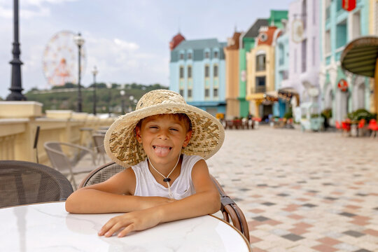 Family with children, visiting Vinpearl, island near Nha Trang, connected with a cable car, beautiful gothic buldings and colorful houses