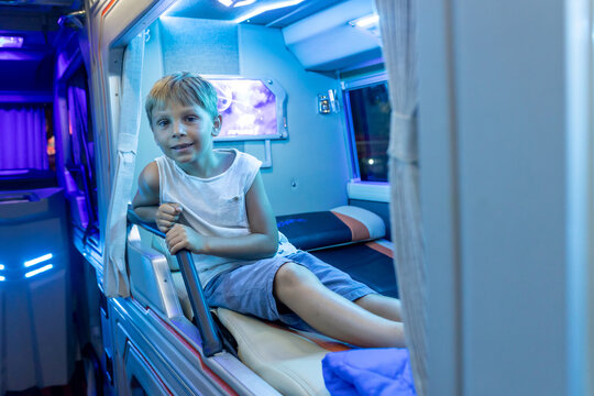 Child, boy, traveling in a sleeper bus in Vietnam, bed seat in the bus, kid on vacation summer