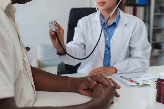 Doctor examining patient with stethoscope during medical check up