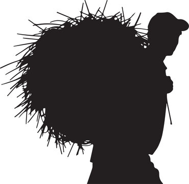 Silhouette of a man carrying a large bundle of sticks