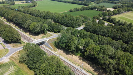 Aerial view of highway in countryside landscape. Road destination drone photography. Drone view of concrete road, transportation and traffic theme.  © Laura