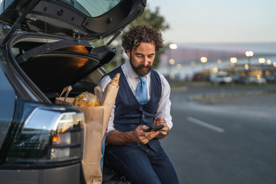 Man connecting with smart phone after grocery shopping trip
