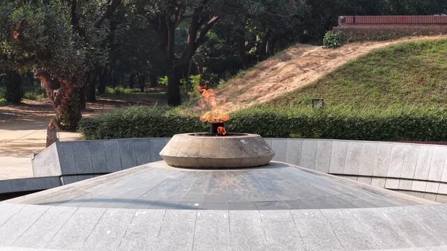 Close ground level view of the burning eternal flame at Suhrawardy Udyan in Dhaka