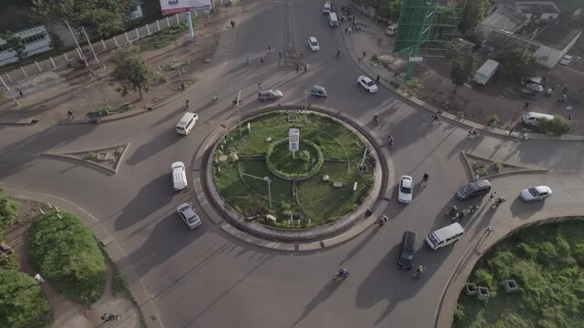 Drone static shot of the Patel's Roundabout in Kisumu city, Kenya with traffic moving in and out of the roundabout