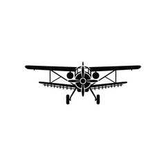 Crop duster biplane silhouette flying low over agricultural fields during daytime with clear sky © NOYAN STOCK
