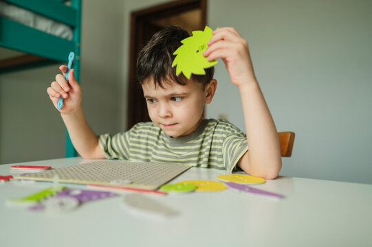 Boy learning mechanics with educational toy indoors