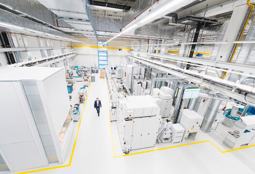 Businessman walking in a factory