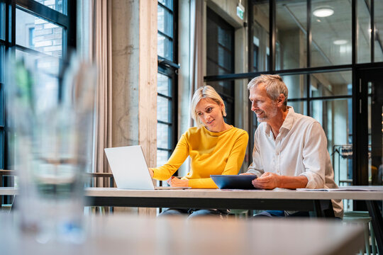 Employees collaborating and planning in a modern office meeting