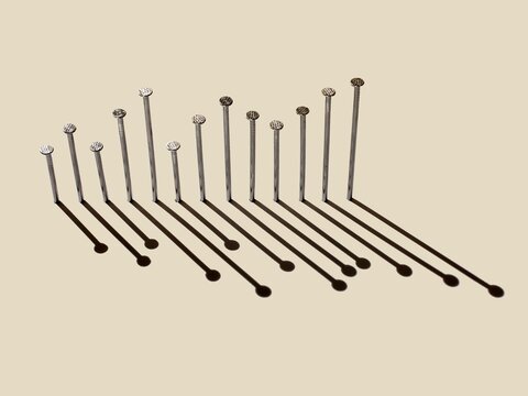 Row of nails with long shadows arranged as a progress graph