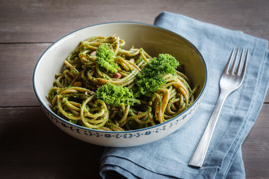 Bowl of whole-grain spelt pasta with kale and hazelnut pesto