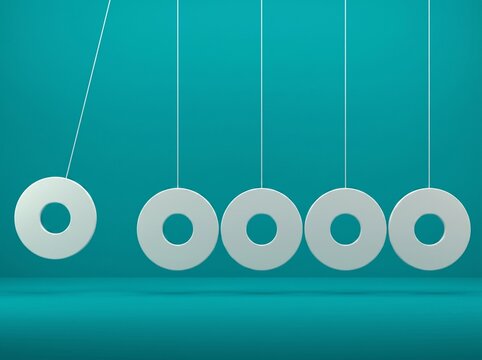 Close-up of a Newton's Cradle with Moving Balls on a Blue Background
