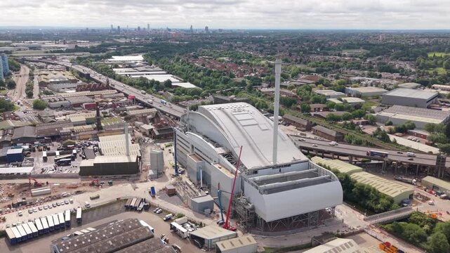 Aerial drone footage of a modern energy recovery facility in the West Midlands, England. Large industrial infrastructure for waste management, electricity generation and sustainable urban development