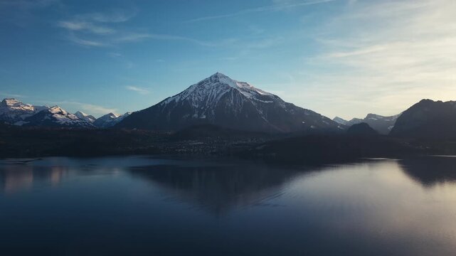 Drone shot of Mount Niesen and its reflection on Lake Thun Switzerland