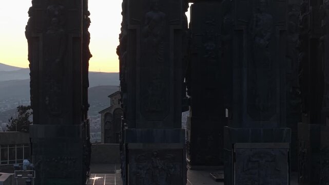 Lateral telephoto footage capturing detailed columns of the Chronicle of Georgia, emphasizing creative composition with repeating forms and open negative space.
