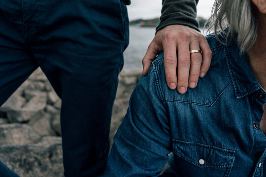 Married son putting hand on father's shoulder