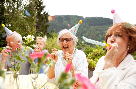 Seniors celebrating birthday oarty in garden