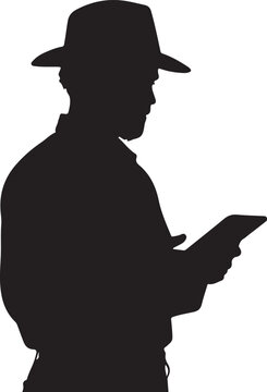 Silhouette of man in hat reading a tablet