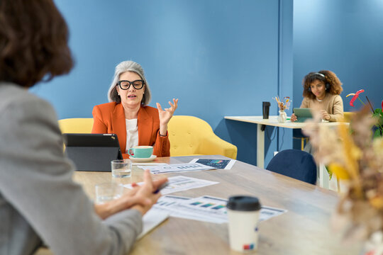 Professionals discussing strategy during a meeting in modern office