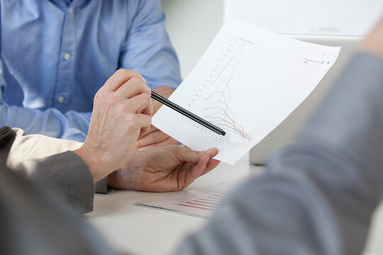 Businesspeople in informal meeting discussing new strategies