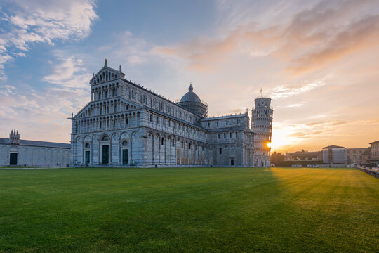 Italy, Tuscany, Pisa, View to Pisa Cathedral and Leaning Tower of Pisa from Piazza dei Miracoli at sunset
