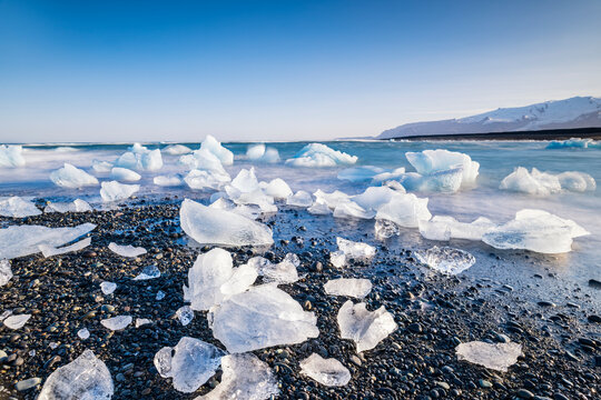 Glacial ice chunks on black sand at Diamond Beach in Iceland