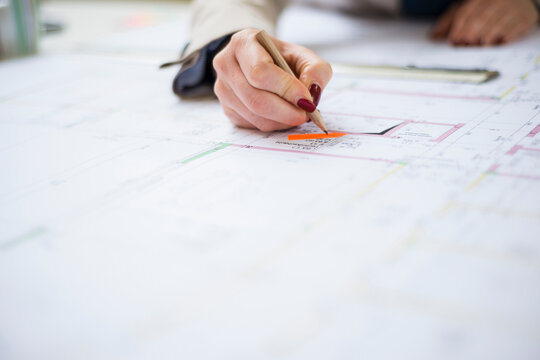 Close-up of architect working on construction plan
