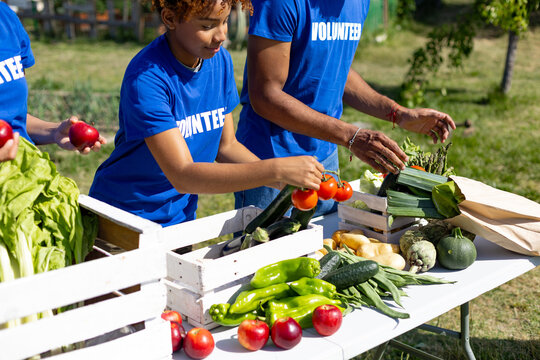 Volunteers preparing fresh produce for community food distribution
