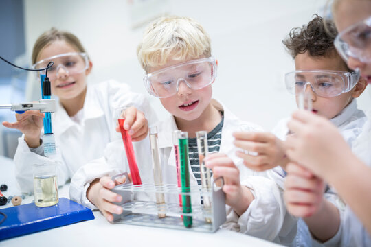 Students conducting liquid experiments in a science classroom using test tubes